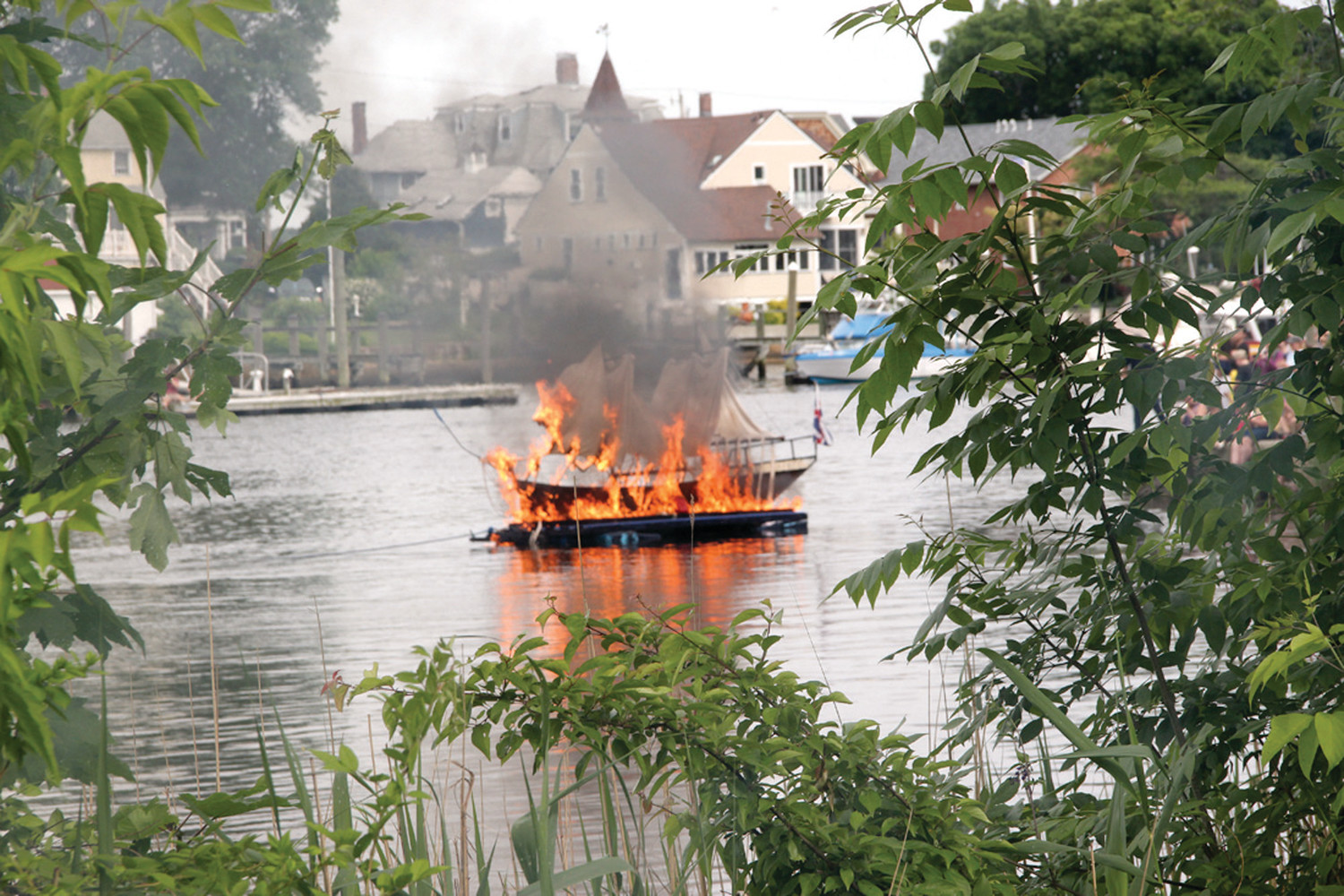 ABLAZE: To the delight of spectators, the Gaspee burns in Pawtuxet Cove.